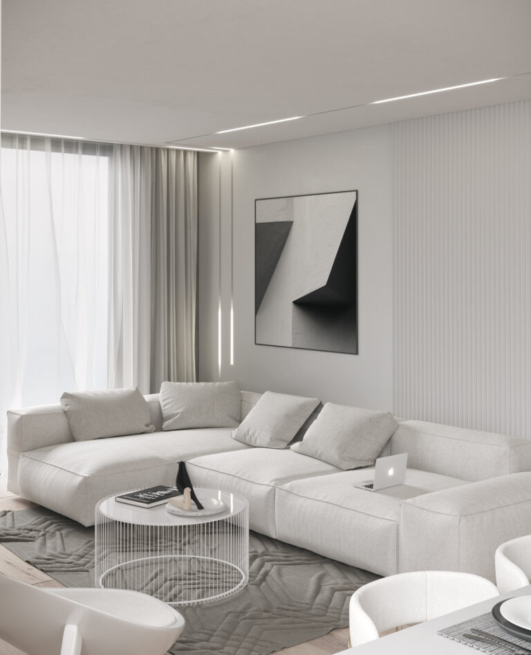 Light grey corner sofa below a black and white abstract artwork, with a fluted white wall, linear ceiling lights and sheer curtains