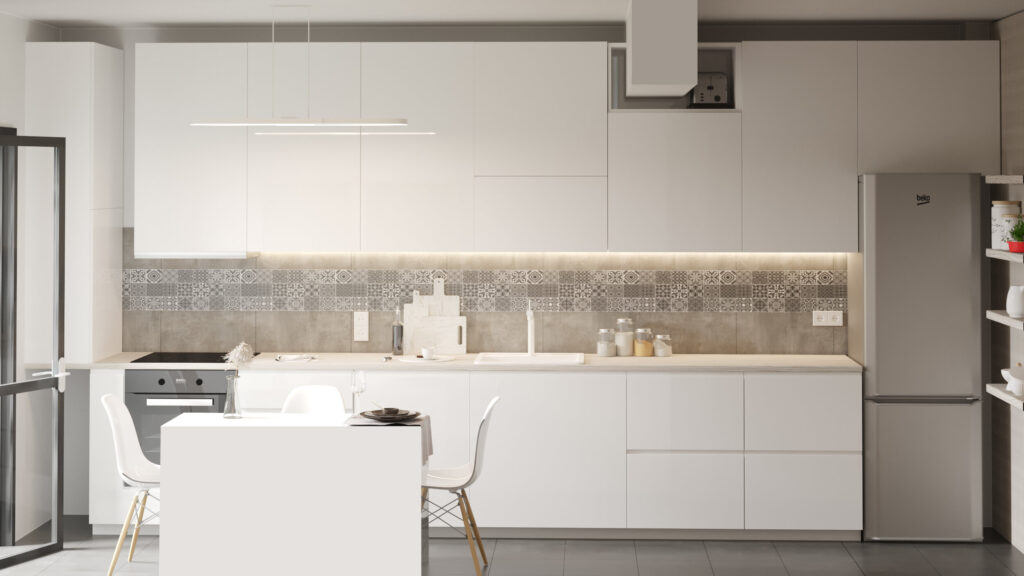 Bucătărie cu dulapuri albe fără mânere, faianță gri cu model, frigider inox și o masă mică albă