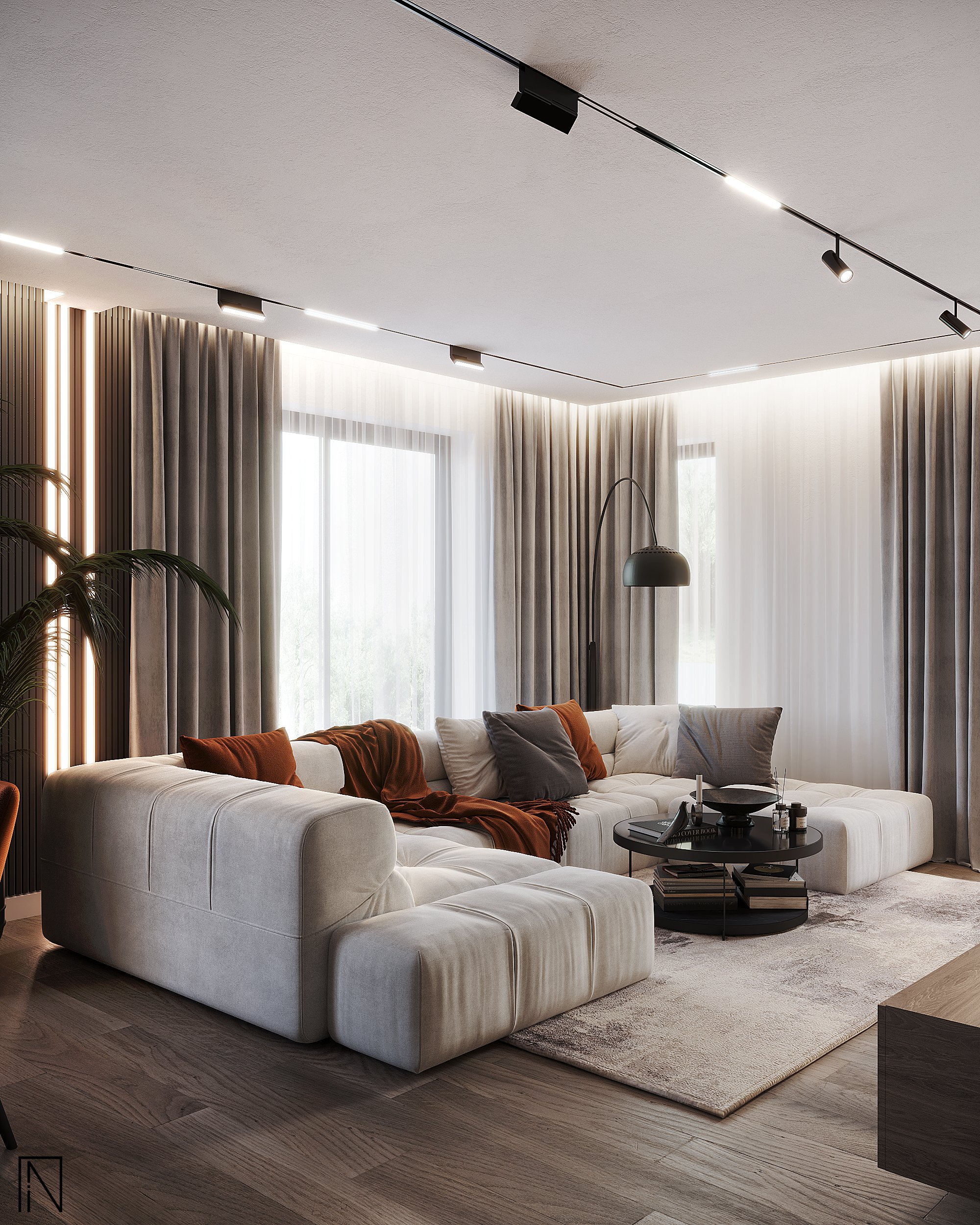 Living cu o canapea modulară mare, alb-gri, cu perne ruginii și gri, măsuță rotundă neagră, lampă arcuită și draperii gri