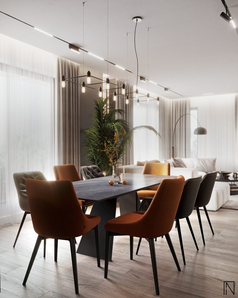 Masa de dining văzută spre living, cu lustră geometrică, un palmier mare și canapeaua albă lângă ferestre